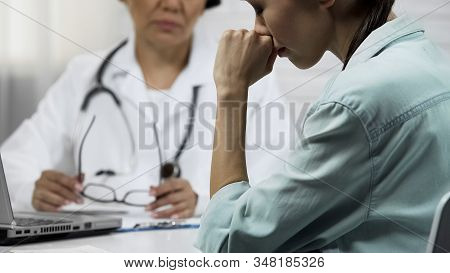 Young Patient Finds Out About Incurable Disease, Female Doctor Telling Bad News