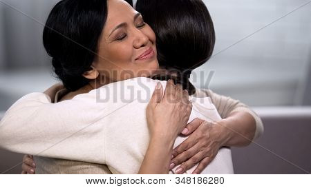 Mother Embracing Young Daughter, Empathy And Tenderness, Love And Maternity