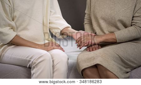 Caring Daughter Holding Mothers Hand, Comforting And Supporting Her, Relations