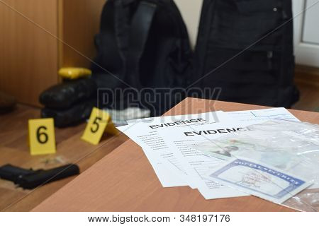 Evidence Labels And Green Card With Ssn Number Lies On Table With Big Amount Of Items As Evidence In