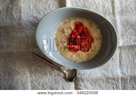 Summer Breakfast With Oatmeals And Fres Organic Strawberries On Rustic Wooden Table