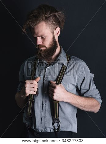 Young, Handsome Man With A Beard Posing On A Black Background In The Studio.