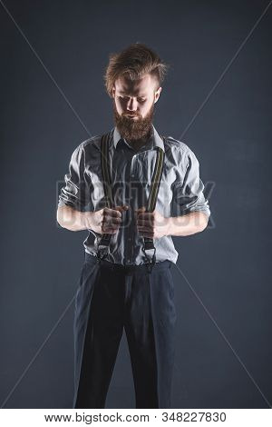 Young, Handsome Man With A Beard Posing On A Black Background In The Studio.