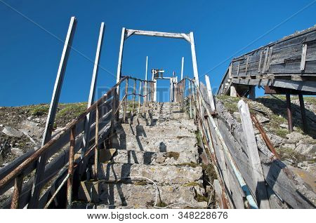 An Old Concrete Staircase With Rusty Iron Railings