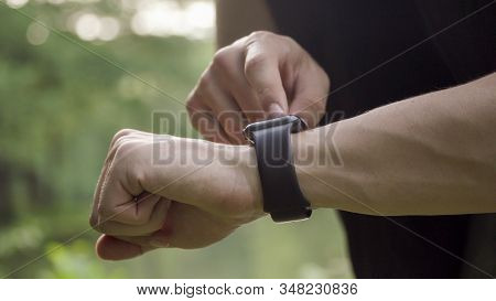 Making Various Gestures With A Finger On A Touch Screen Of A Smart Watch Wearable Device.