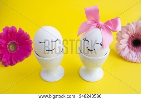Easter Composition With White Eggs In White Coasters On A Yellolw Background. Closeup.