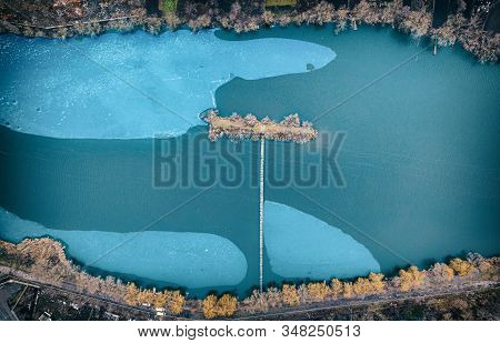 Drone View, Small Island, With Long Wooden Bridge, In The Middle Of The River, Autumn Landscape.