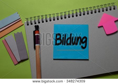 Bildung Write On A Sticky Note Isolated On Office Desk. German Language It Means Education