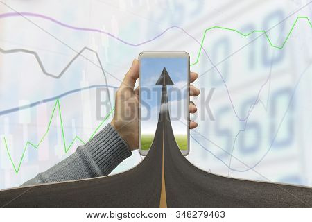 Highway Road Going Up As An Arrow In Mobile Phone With Stock Graph Background. Concept Business, Sym