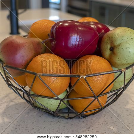Photo Square Wired Geometric Fruit Basket With Fresh Fruits At The Kitschen Island Of Home