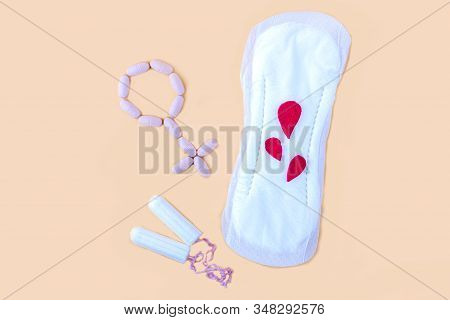 Protective Menstrual Pad, Cotton Tampons And Gender Symbol Made From Pink Pain Pills. The Concept Of