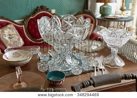 Vintage Lead Crystal Punch Bowl And Cups On A Wooden Table At An Antique Store. Maine, Usa