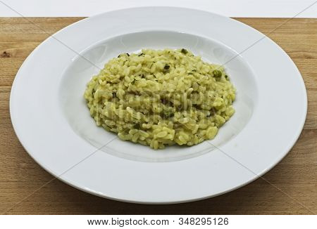 Risotto With Asparagus On Wooden Table. Italian Food