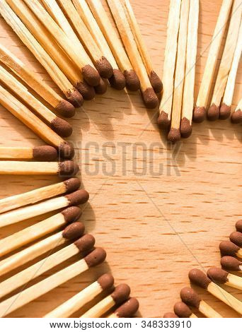 Wooden Safety Matches On A Wooden Background Arranged In The Shape Of A Heart. Matchsticks In The Sh