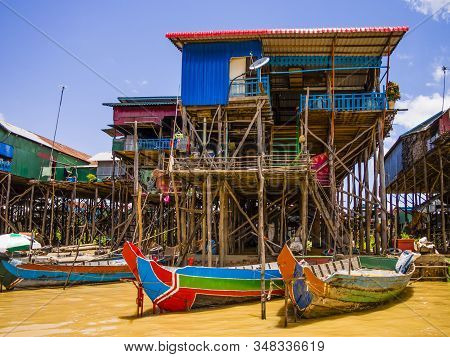 Traditional Kampong Phluk Floating Village With Multicolored Boats And Stilt Houses, Tonle Sap Lake,