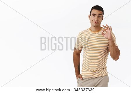 Skeptical Young Man Giving His Permission, Showing Not Bad Gesture, Smirk And Looking Judgemental, M