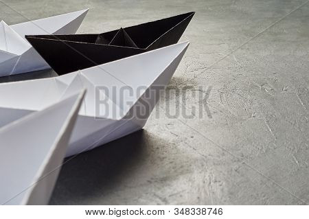 Business Concept, Paper Boat, The Key Opinion Leader, The Concept Of Influence. One Black Paper Boat