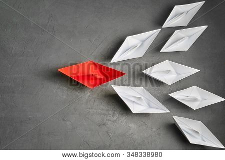 Business Concept, Paper Boat, The Key Opinion Leader, The Concept Of Influence. One Red Paper Boat A
