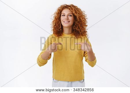 Proud, Attractive Lucky Redhead Curly Girl In Yellow Sweater, Got Promoted, Pointing Herself, Smilin