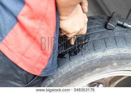 Series Of Mechanic Patching Puncture Tubeless Tire. Plugs Being Inserted Into Puncture Area.