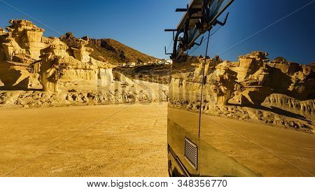 Camper Car On Parking Area At Eroded Yellow Sandstone Formations, Enchanted City Of Bolnuevo, Murcia