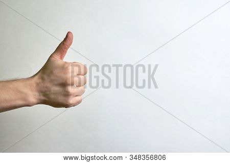 Thumb Male Right Hand On A White Background With Place For Text. Like, Approval, Classy, Compliment 