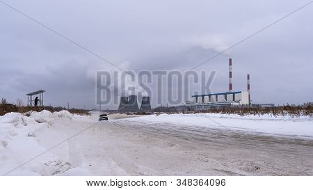 Russia, Novosibirsk - November 30, 2019. An Unknown Person Takes A Video On A Tripod On A Hill On A 