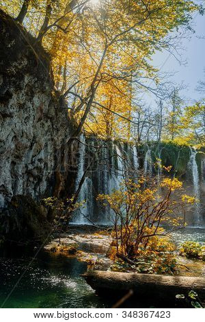 Beautiful Waterfalls Of Croatian National Park Plitvicka Lakes With Sun Shining Through The Trees.