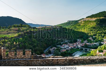 Panoramic View Of Veliko Tarnovo From Tsarevets Hill. Medieval Ruins Of Tsarevets Fortress And Typic