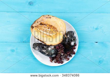 Moldy Melon, Grapes And Avocados On A Plate, Concept Of Stop Wasting Food, Don't Waste Food In Super