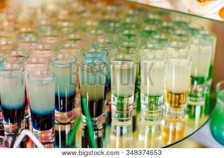 Many Different Colorful Alcoholic Shot Cocktails In Drinking Glasses Green Brown Red And White Color