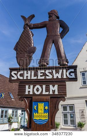 Schleswig, Germany - June 25, 2019: Wooden Sign At The Entrance Of Historic Holm Village In Schleswi