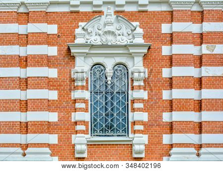 Close-up Of Ancient Vintage Arch Window With Cast Iron White Painted Deorative Lattice And White Ant
