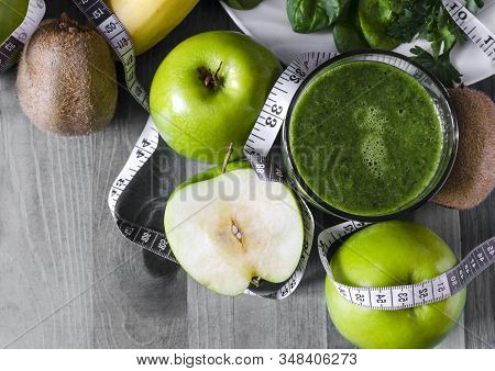 Fruit Green Smoothie In Transparent Bowl Apples And Greens Blue Wooden Background Top View