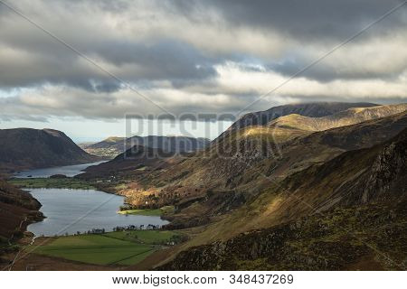Epic Autumn Fall Landscape Of Buttermere And Crummock Water Surrounded By Mountain Peaks In Lake Dis