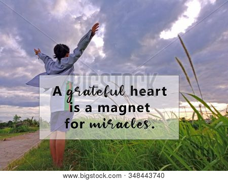 Inspirational Quote - A Grateful Heart Is A Magnet For Miracles. With Blurry Background Of Young Wom