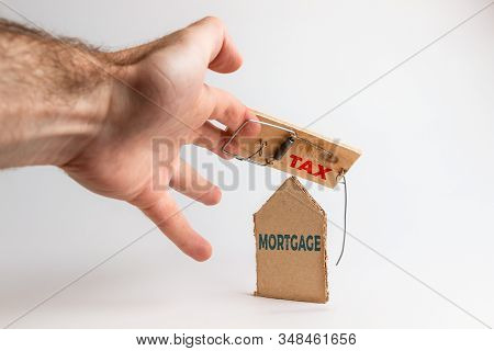 Concept Of Bank Investments And Risks. A Mans Hand Falls Into A Mousetrap, With A Cardboard Insert. 