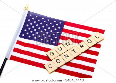 The Flag Of The United States Isolated On A White Background With A Sign Reading Gun Control