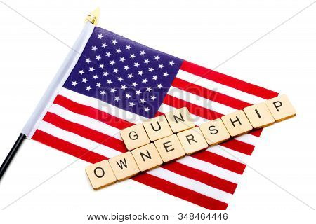 The Flag Of The United States Isolated On A White Background With A Sign Reading Gun Ownership