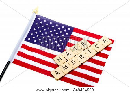 The Flag Of The United States Isolated On A White Background With A Sign Reading Hate America