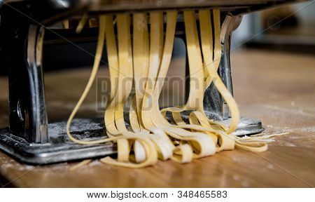 Chef Rolling Dough With A Pasta Machine. Pasta Maker Machine.