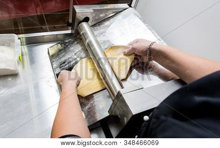 Chef Rolling Dough With A Pasta Machine. Pasta Maker Machine.
