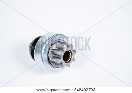 New Spare Parts - Starter Gear Drive For Motor Starter On A Gray Background. Classic Gear Transmissi