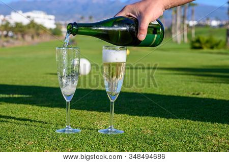 Pouring Of Bubbles White Champagne Or Cava Wine During Golf Competition Event Or Celebration On Gree
