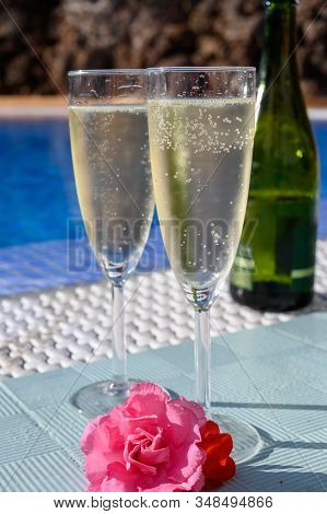 Pool Party With Two Glasses Of Bubbles White Champagne Or Cava Wine, Romantic Event On All Inclusive