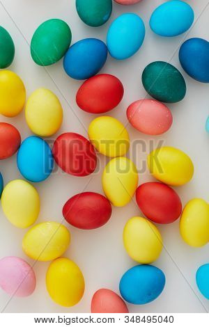 Above View Of Pastel Colored Easter Eggs Arraigned In Minimal Composition On White Background, Copy 