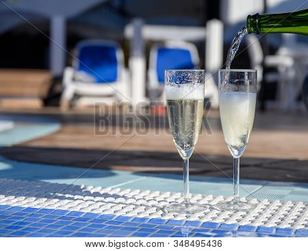 Pool Party With Two Glasses Of Bubbles White Champagne Or Cava Wine, Romantic Event On All Inclusive