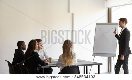Group Meeting Led By Business Trainer In Modern Office Boardroom