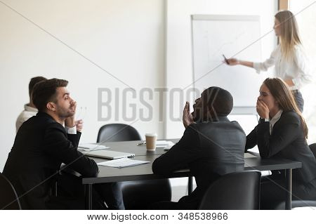 Multi-ethnic Corporate Staff Yawning Taking Part In Boring Seminar