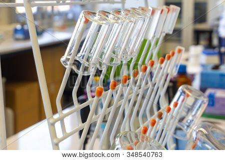 Chemical Glassware Are Drying On The Holder. Glass Beakers In Chemical Scientific Laboratory.